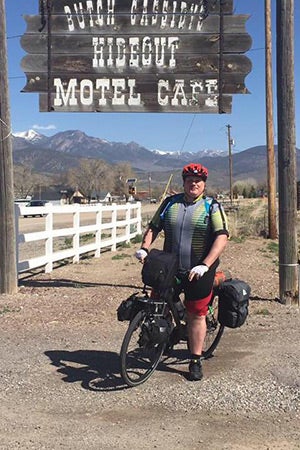 Kevin McCall cycling by Butch Cassidy's Hideout Motel Cafe