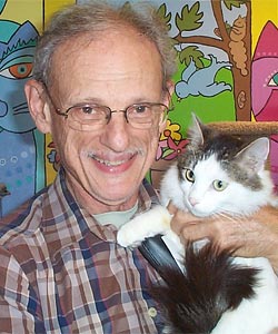 Evan Kalik, founder of Cat Adoption Team in Sherwood, Oregon, holding a cat