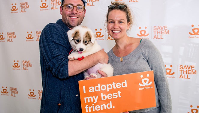 Couple with their adopted puppy