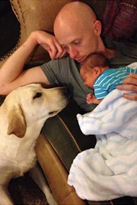 Therapy dog with man and baby