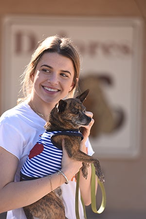 Teenager Katie McEvoy holding a small dog at Dogtown
