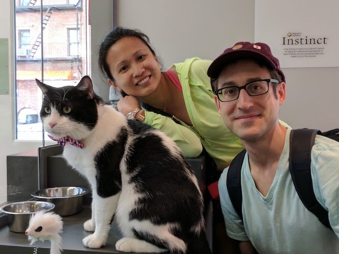Couple with their tuxedo cat
