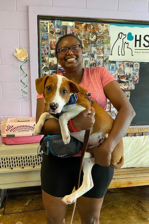 A woman holding a dog she just adopted from the Humane Society of the New Braunfels Area