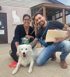 Couple with white dog