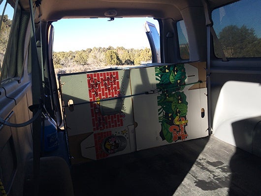Build barrier wall for kennels in back of the van