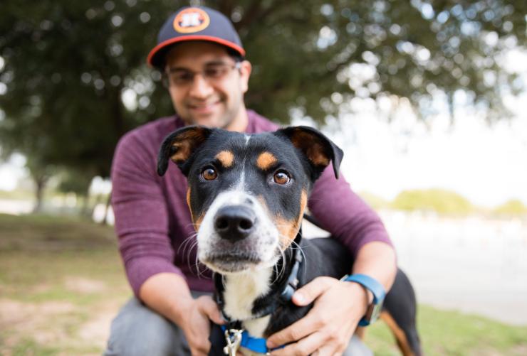 Smiling person outside with a dog in Houston, Texas