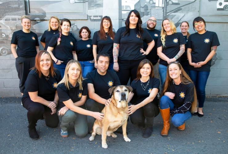 Group shot of first graduates from the SUU Executive Leadership Certification with a dog