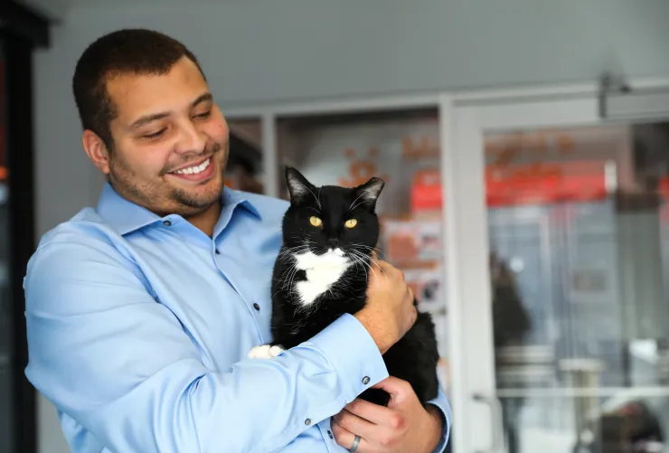 Smiling person holding a cat