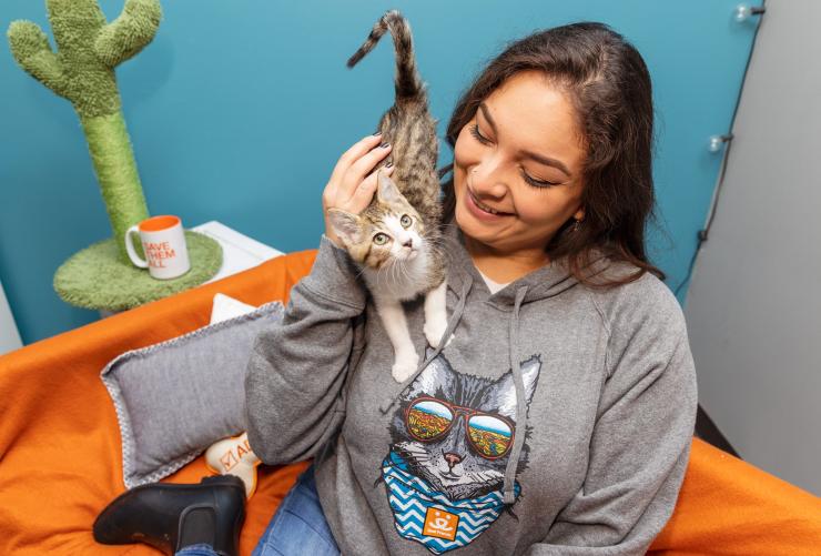 Woman with kitten sitting on shoulder