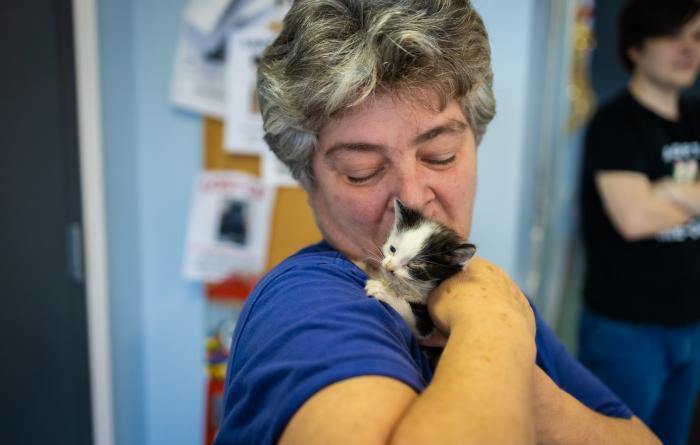 Jeffersonville Animal Shelter staff person holding a small kitten on her shoulder