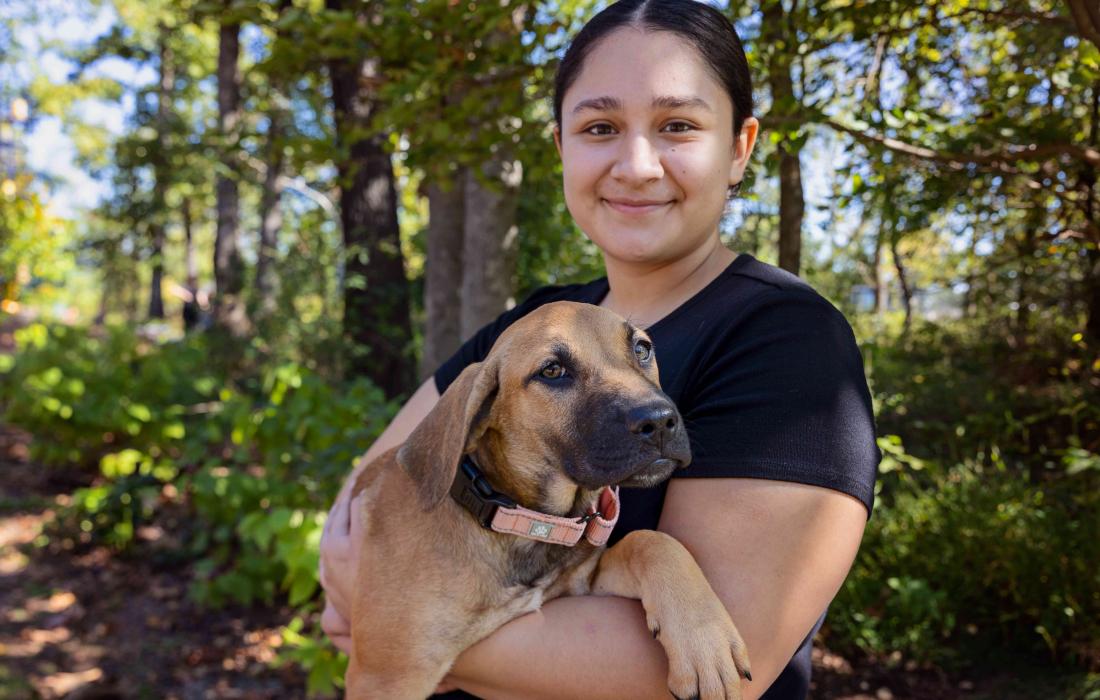 Person holding a puppy at the Northwest Arkansas Super Adoption