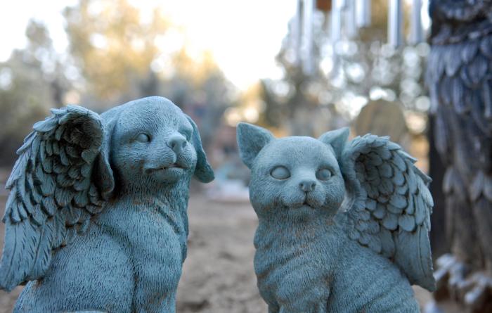 Statues of an angel dog and cat