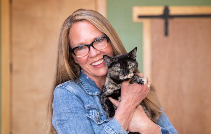Julie Castle holding a tortoiseshell cat