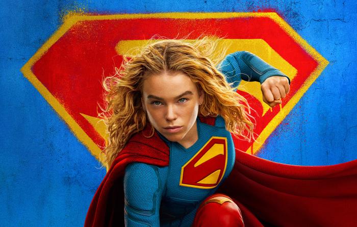 Supergirl with the S emblem behind her