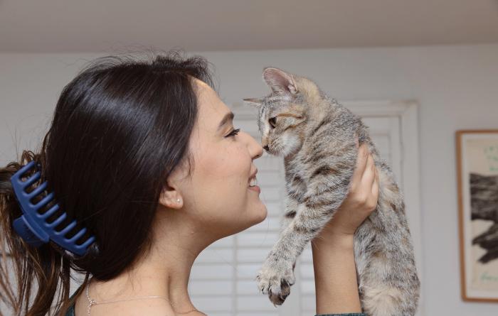 Person nose-to-nose with a kitten she's holding