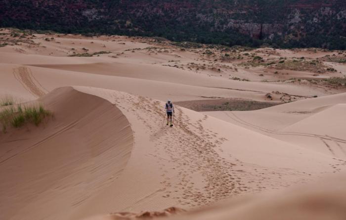 Person running in sand as part of the Grand to Grand Ultra