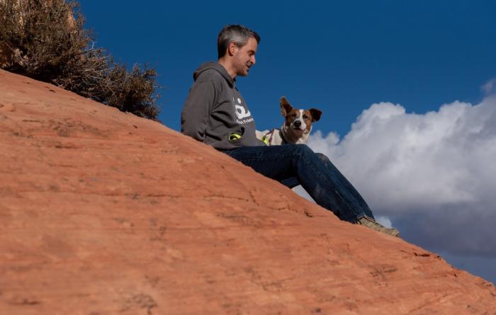 Person hiking with dog in Utah desert