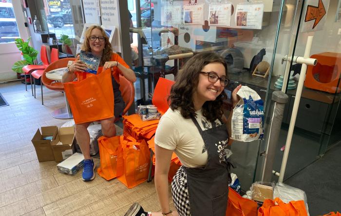 People putting Blue Buffalo pet food into orange Best Friends bags