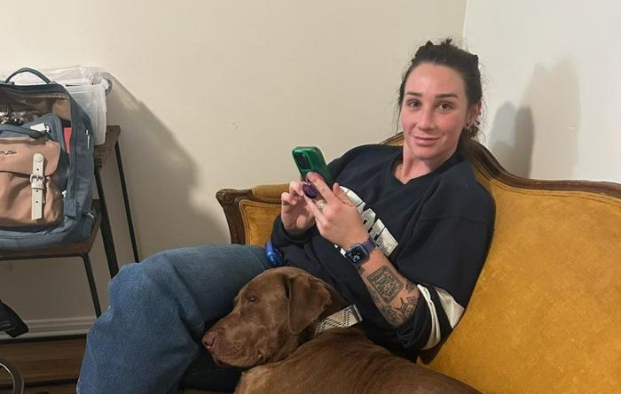 Erin and Spud the dog on the couch together