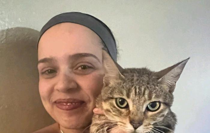 Lourdes Ortiz holding Kiwi the cat