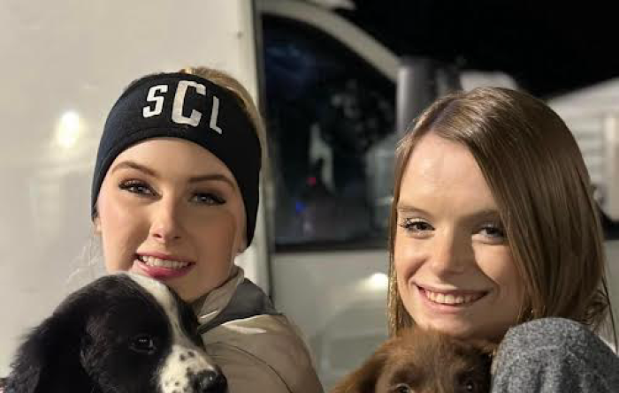 Skylar Clark and her sister Halee loading puppies for a transport