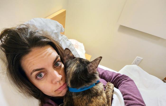 Katy Bentz in bed on a sleepover with Beauty the cat