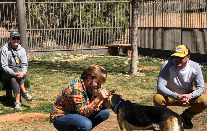 Volunteer from MenHealing petting a dog