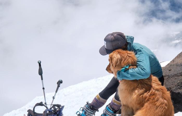 Emily Keddie hugging a dog outside in the snow