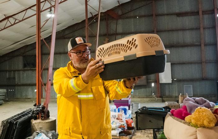 Volunteer holding a cat crate