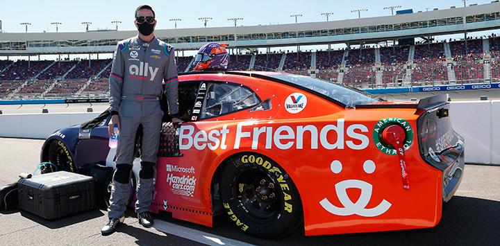 Alex Bowman standing next to his Ally Racing car with Best Friends wrap