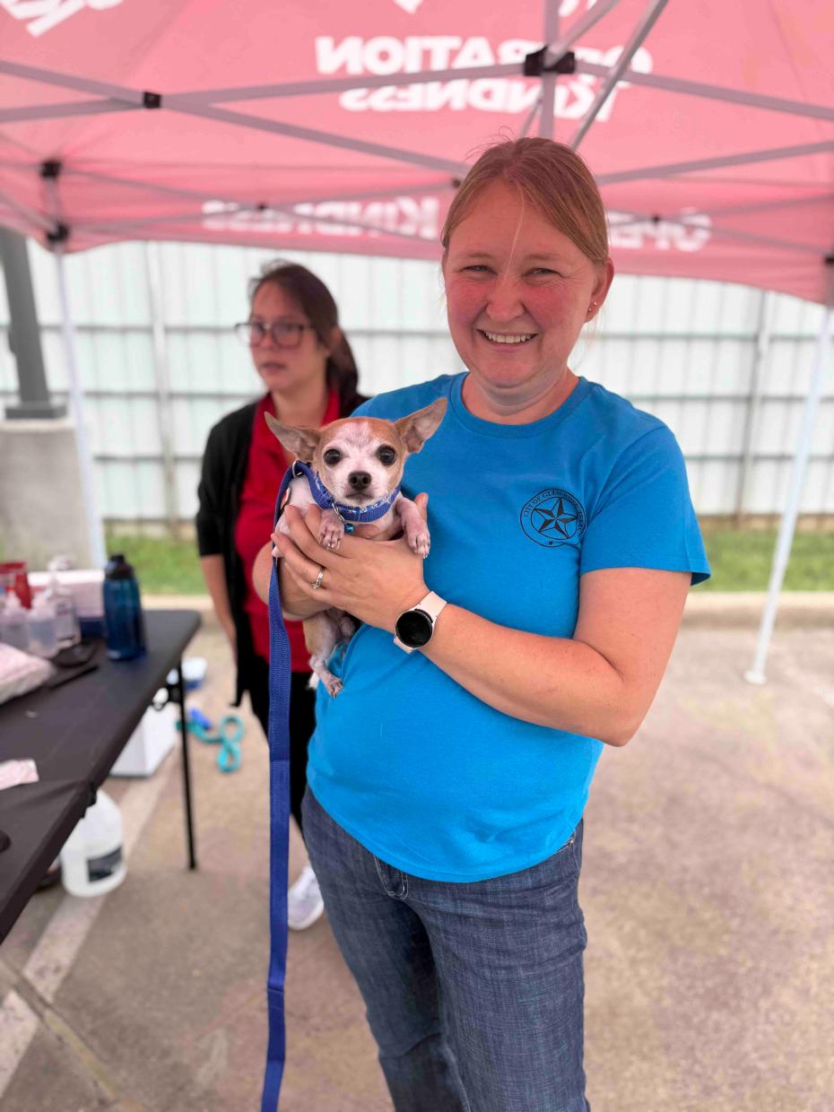 Christy Wilson holding a small dog