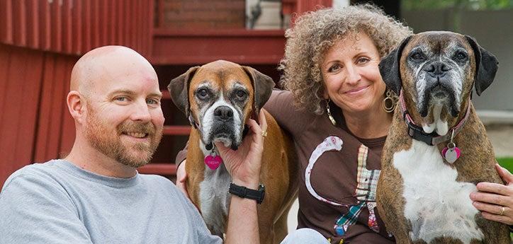 two dogs with a couple who run their own small animal rescue group