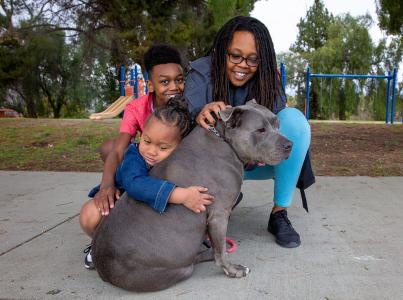 Happy family hugging their newly found dog.
