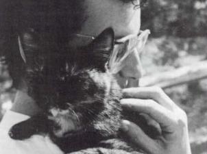 Vintage photo of man holding cat