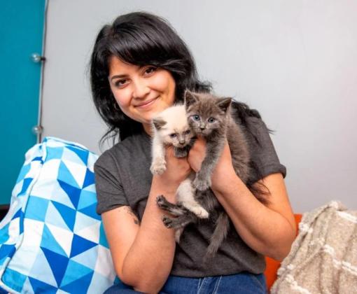 woman holding two kittens