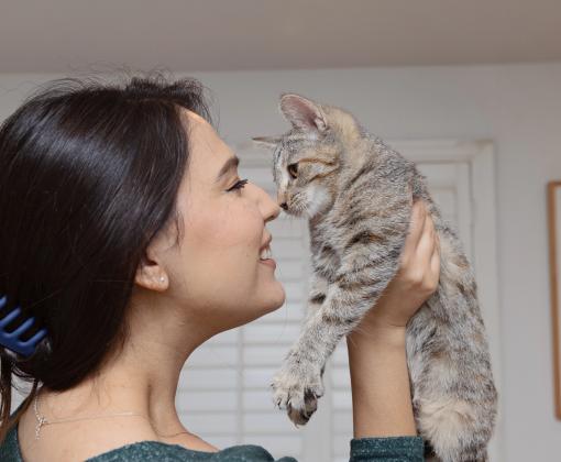 Person nose-to-nose with a kitten she's holding
