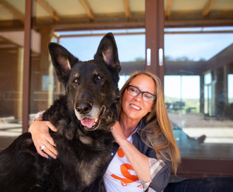 Julie Castle hugging Shadow the dog