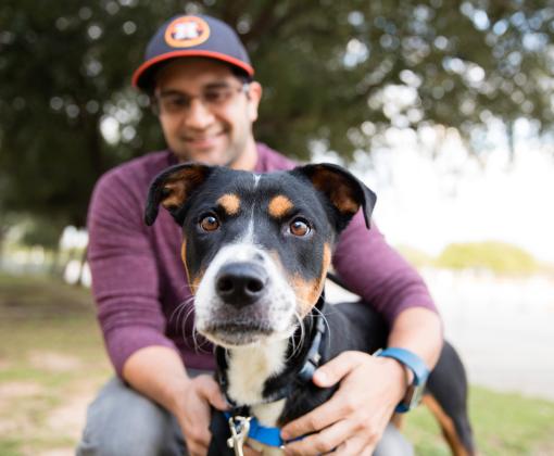 Smiling person outside with a dog in Houston, Texas