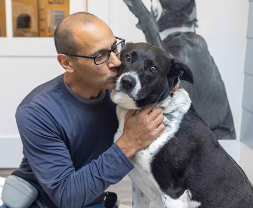 Person hugging a dog - remembering someone who loved dogs