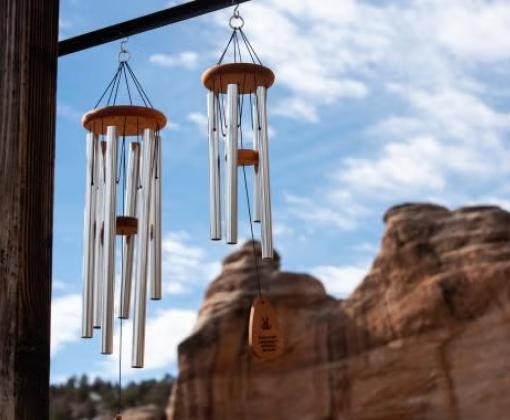 Two windchimes in front of red rock cliffs