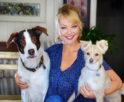 Charlotte Ross hugging two dogs