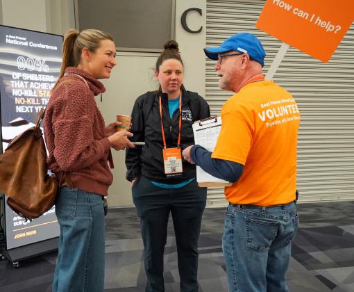 Volunteer talking to Best Friends National Conference attendees