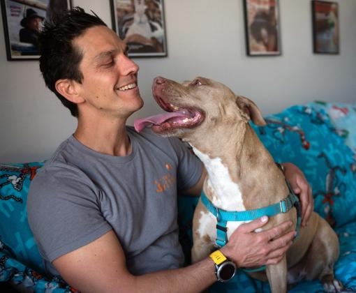 Adam with Queenie the dog on a sleepover