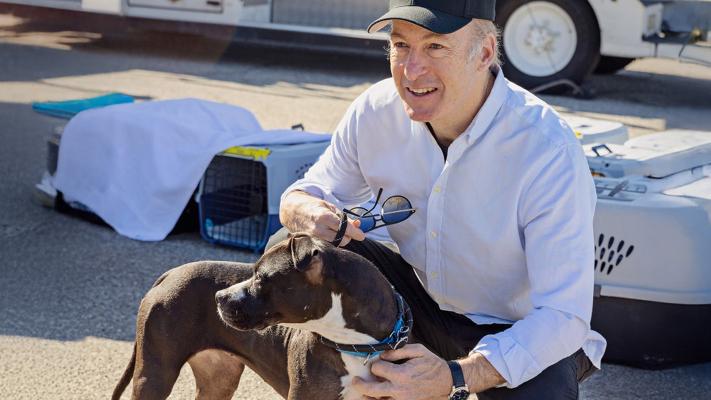 Bob Odenkirk with a dog helping at a flight transport event during the Los Angeles wildfires