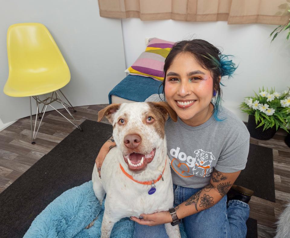 Smiling person with a dog in a home setting