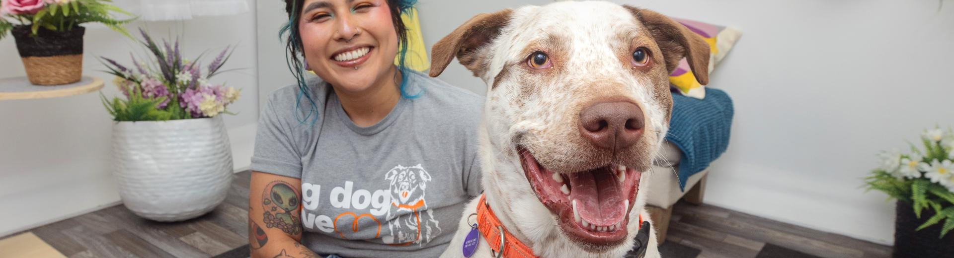 Smiling person sitting on a comfortable chair with a dog