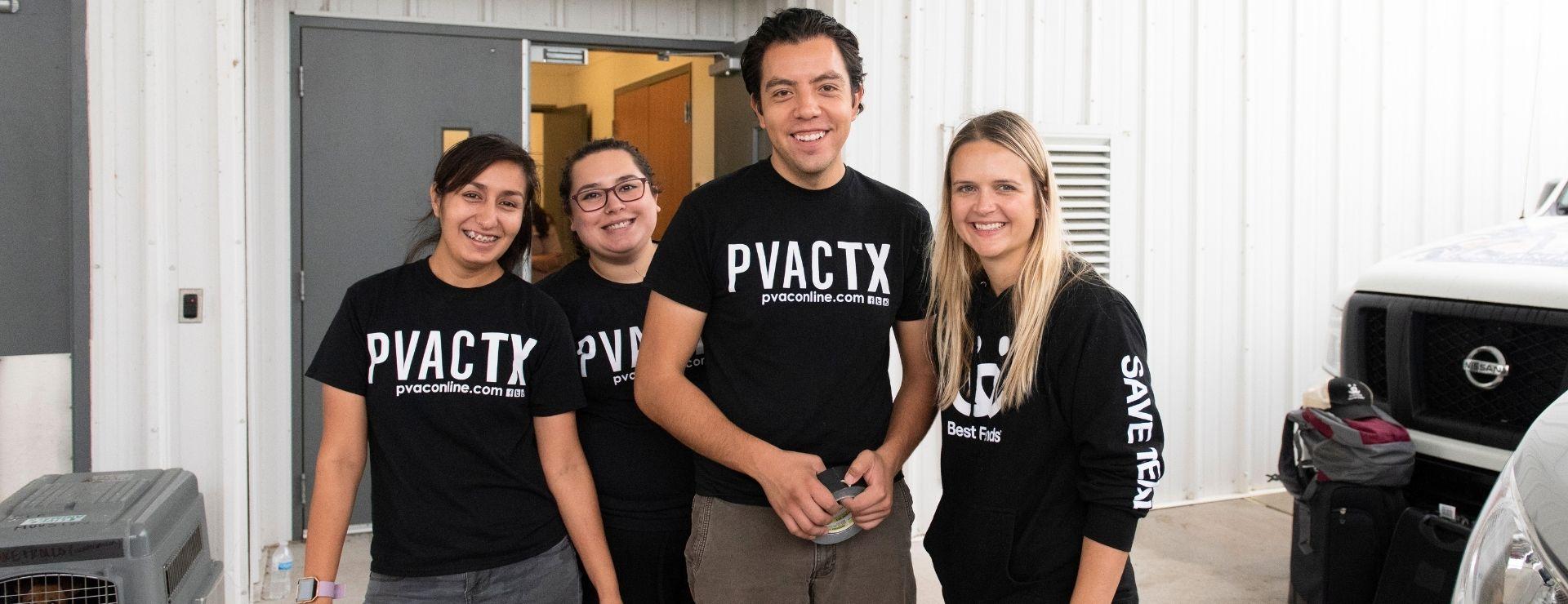 Three women and a man posing for a group photo with shirts using the logo PVACTX