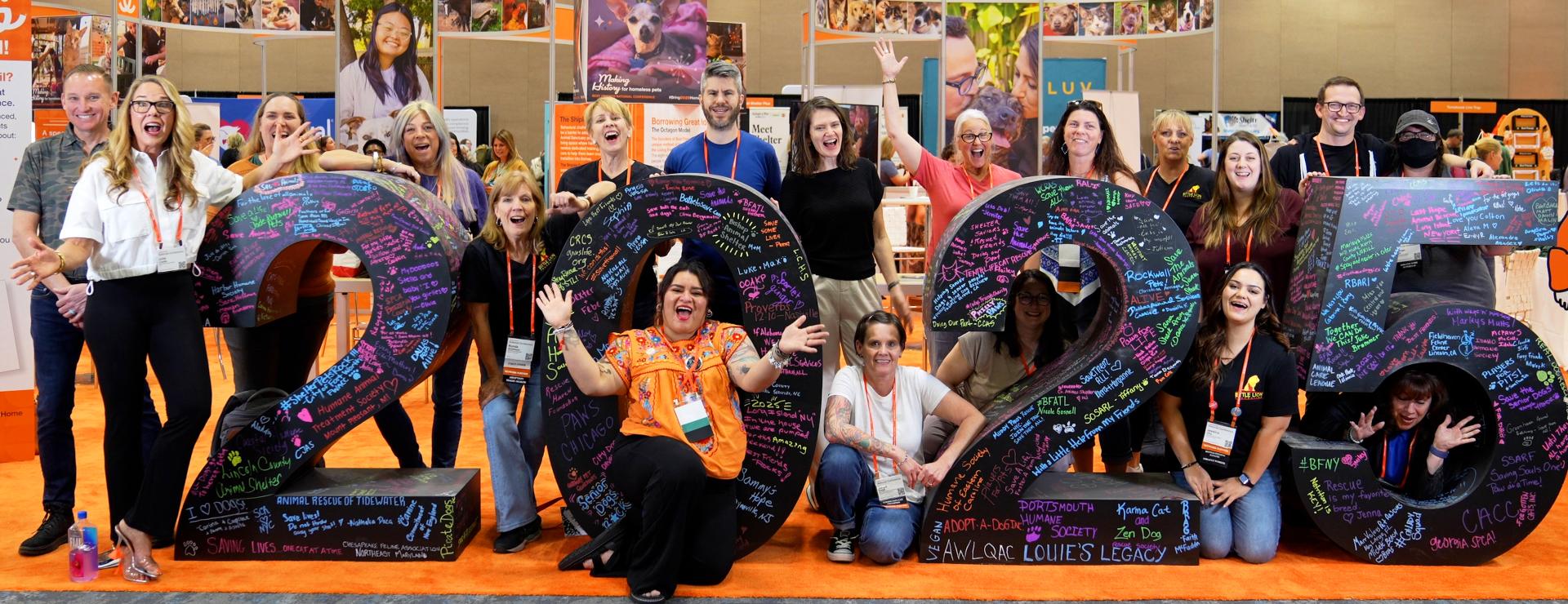 Group of people around a large sculpture of the number 2025