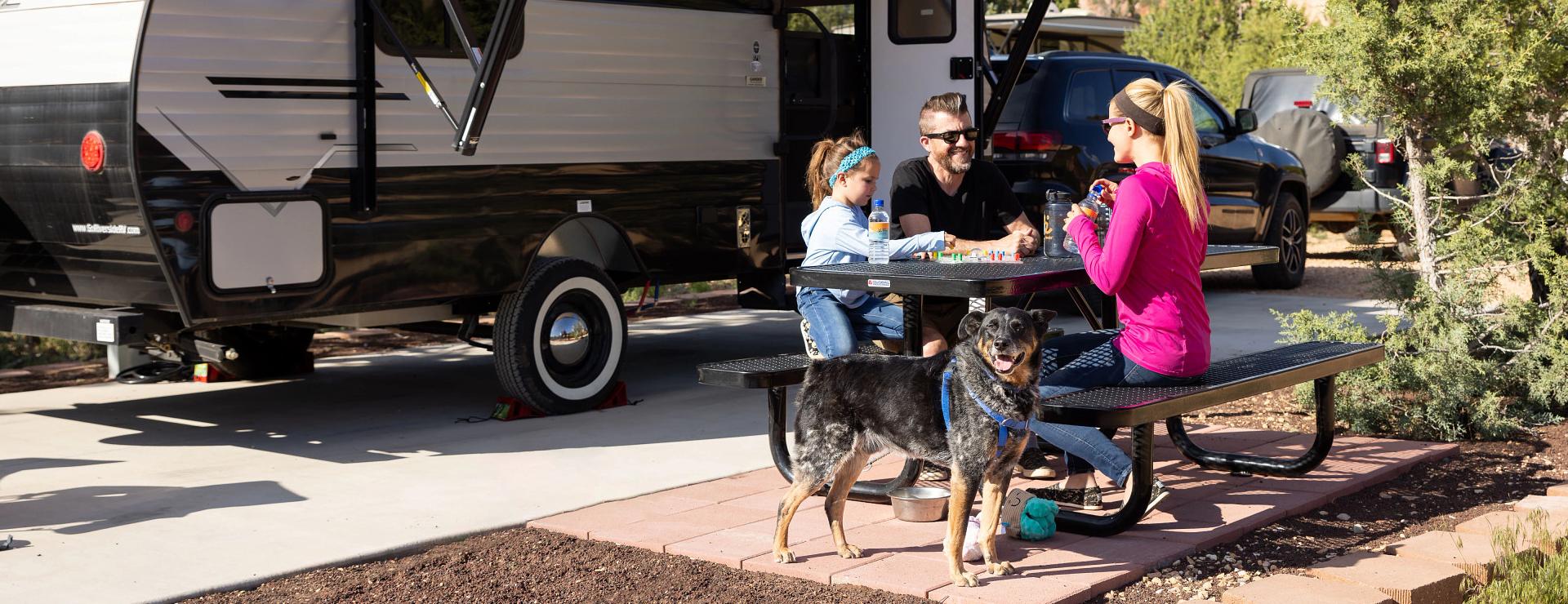 Family sitting at a picnic bench at the Best Friends Animal Sanctuary RV park