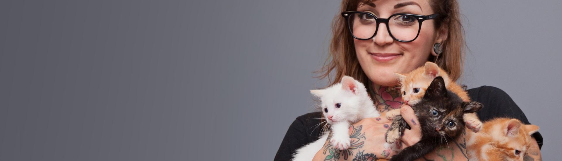 woman holding kittens